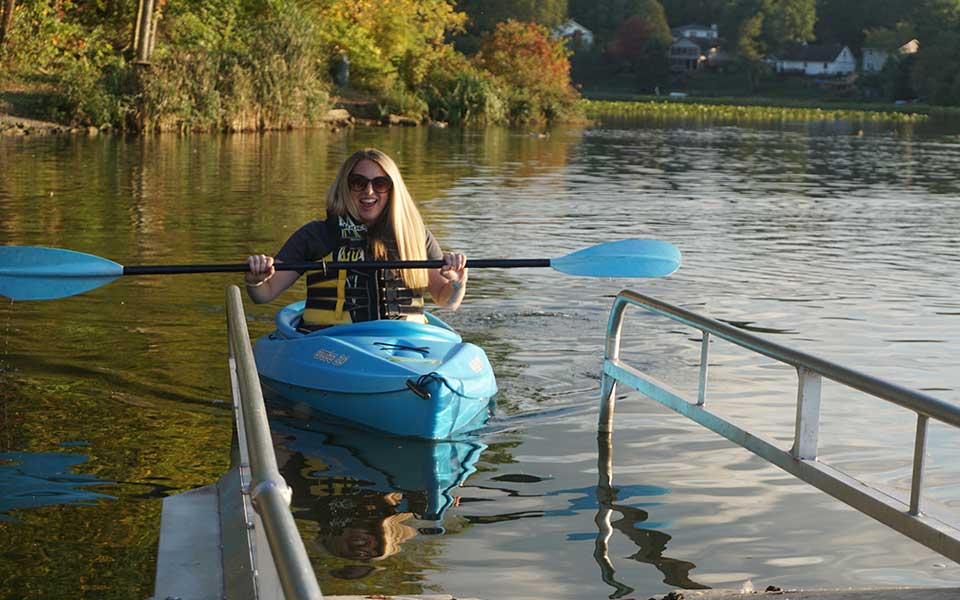 kayaker on water approaching adaptive launch